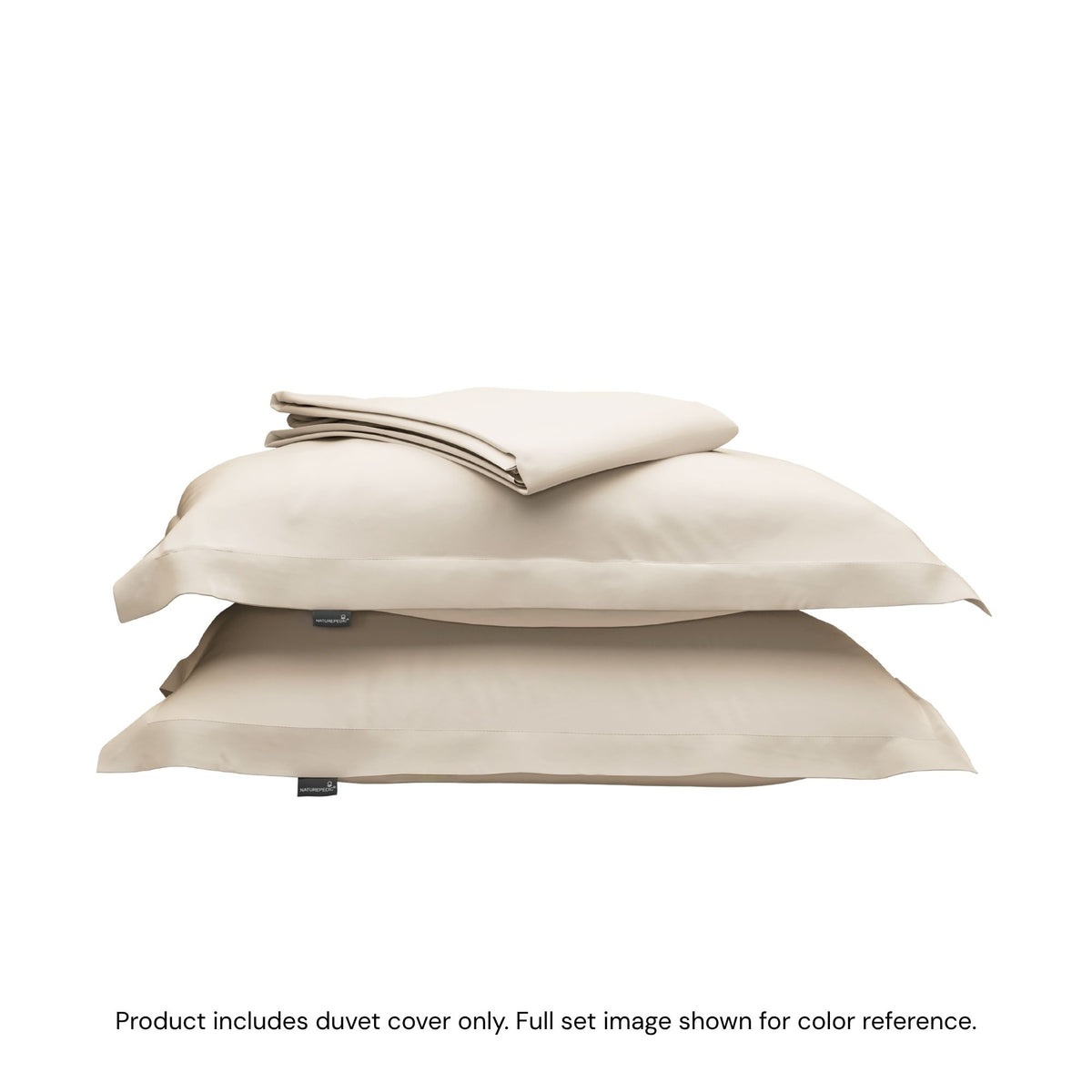 A folded duvet cover sitting on top of two pillow shams #color_cream