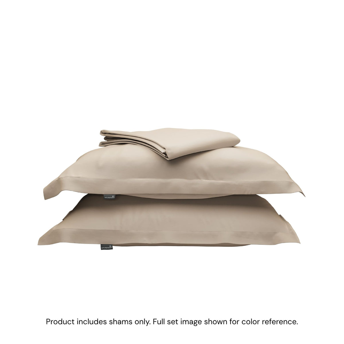 A folded duvet cover on top of two pillow shams. #color_sand