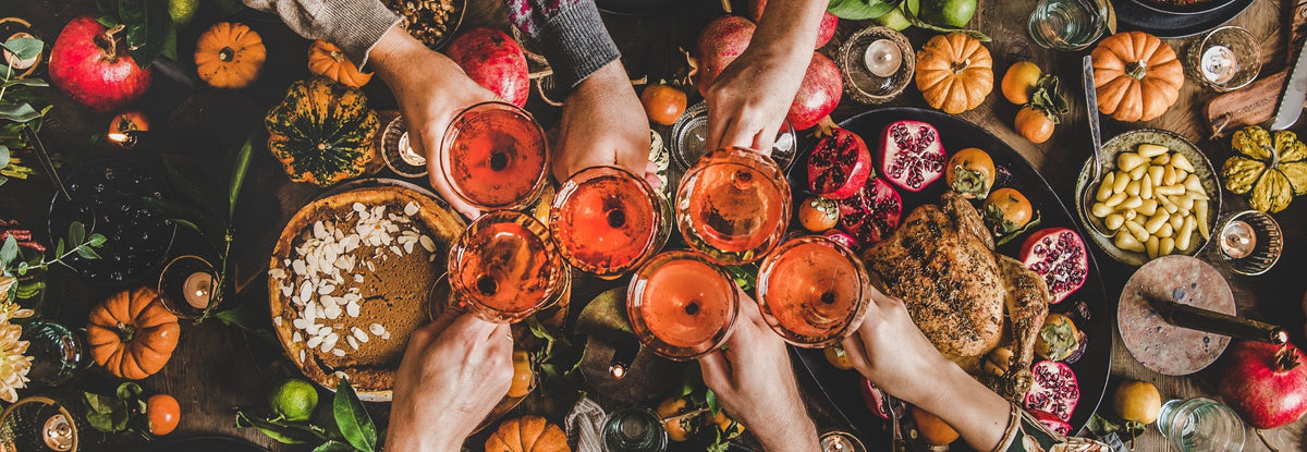 Family enjoying Thanksgiving dinner at a table outdoors
