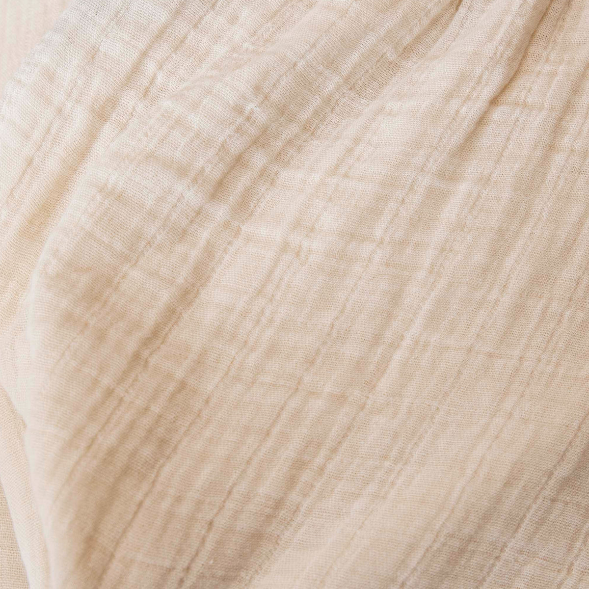 Close-up of beige muslin weave texture