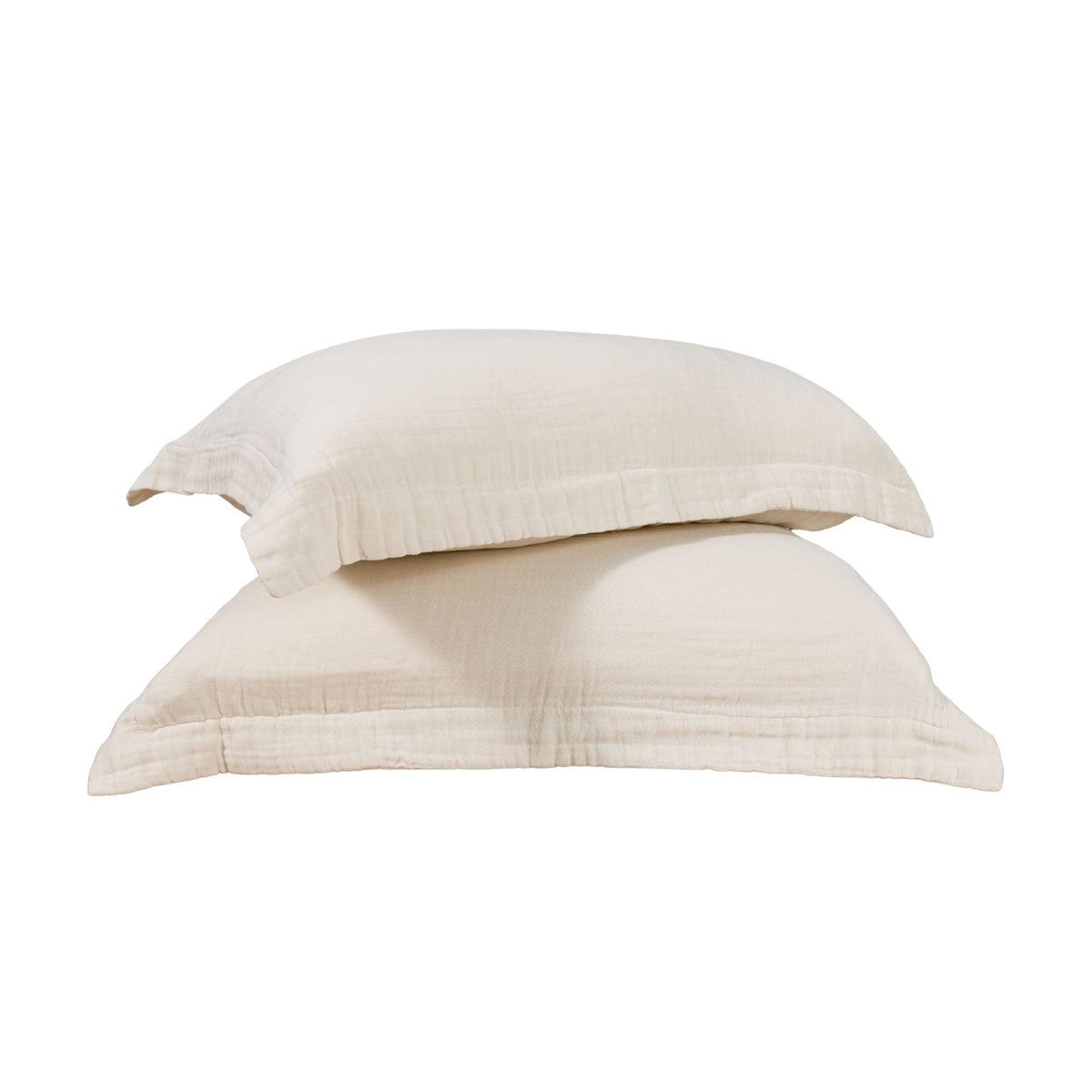 Two muslin pillow shams against a white background. #color_cream