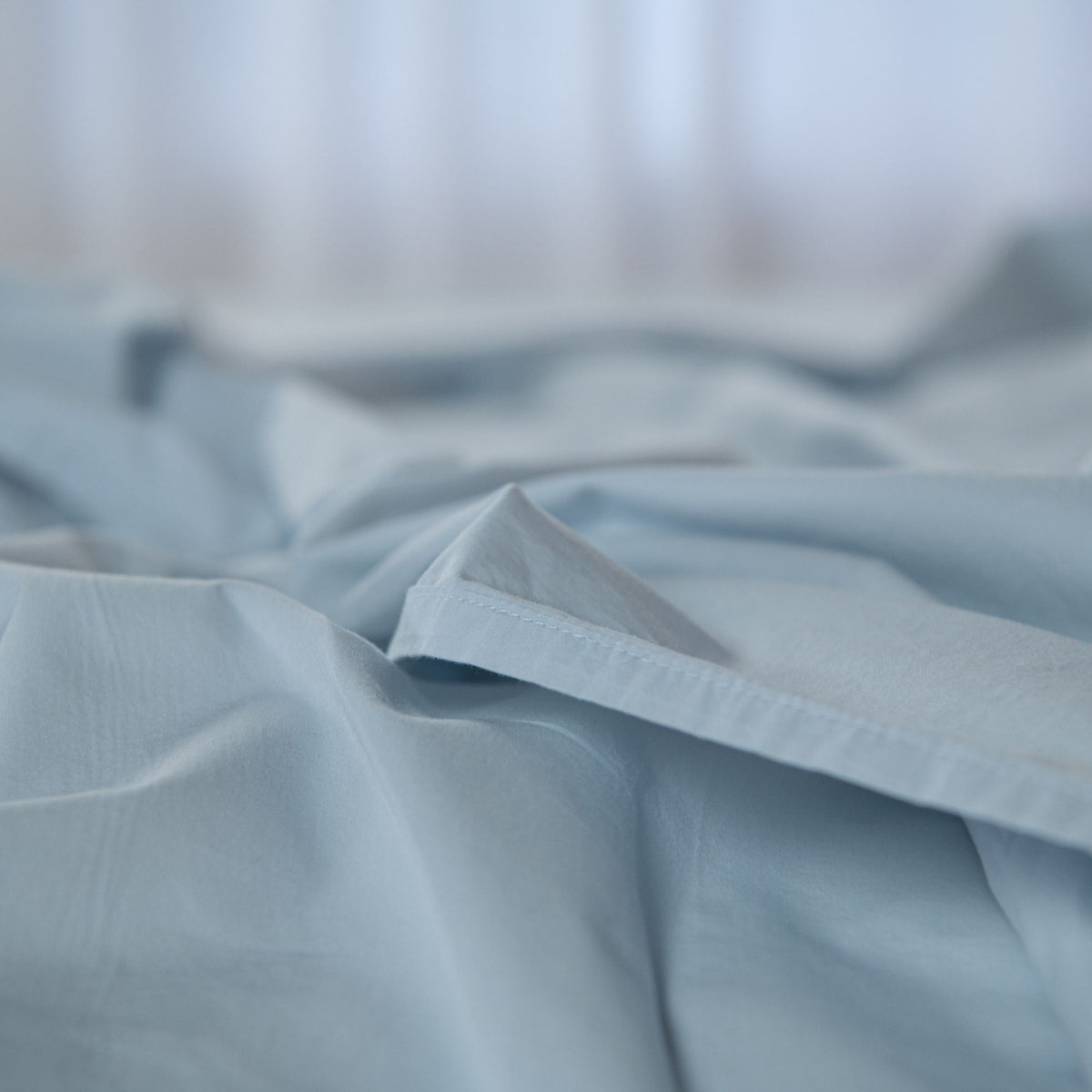 Close-up of light blue fabric with a blurred background