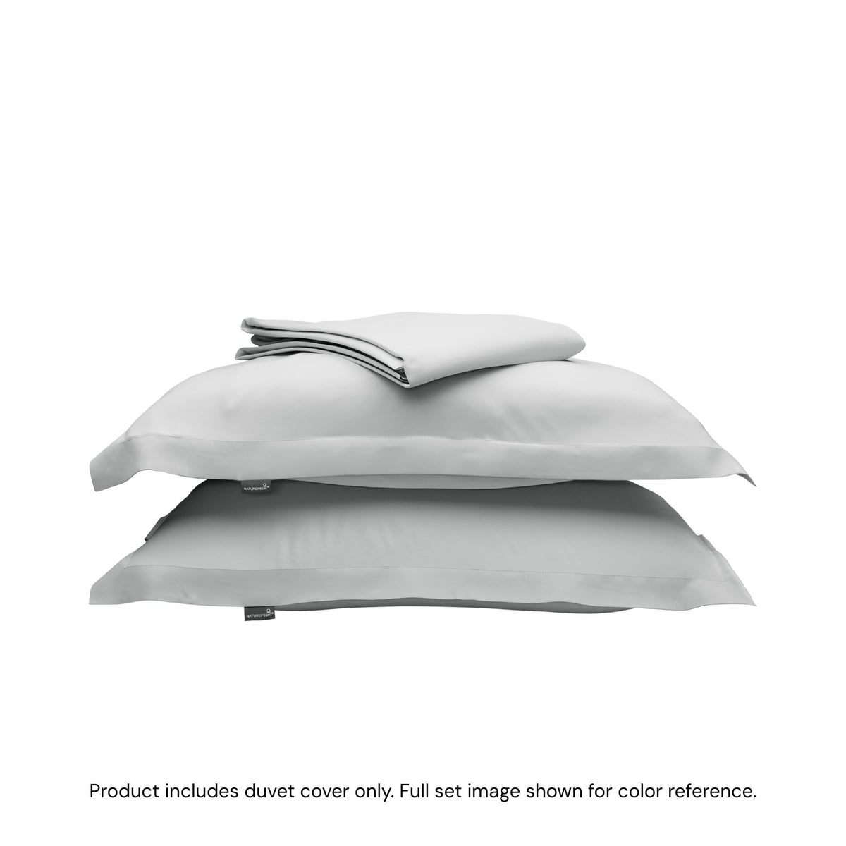 A folded duvet cover sitting on top of two pillow shams #color_mist
