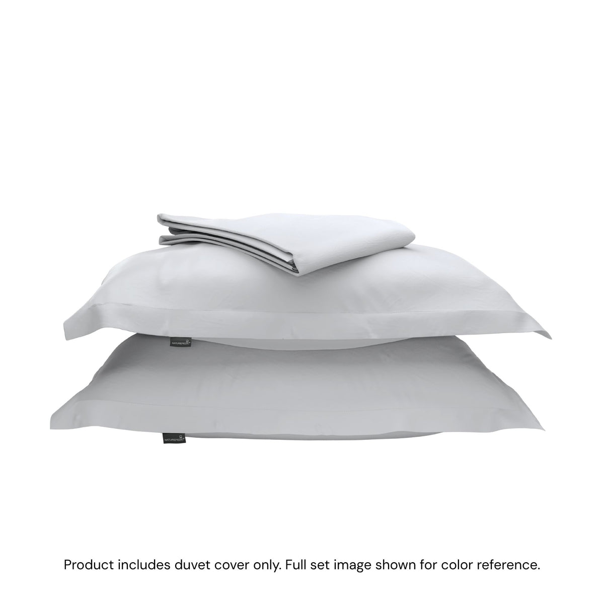 A folded duvet cover on top of two shams against a white background #color_mist