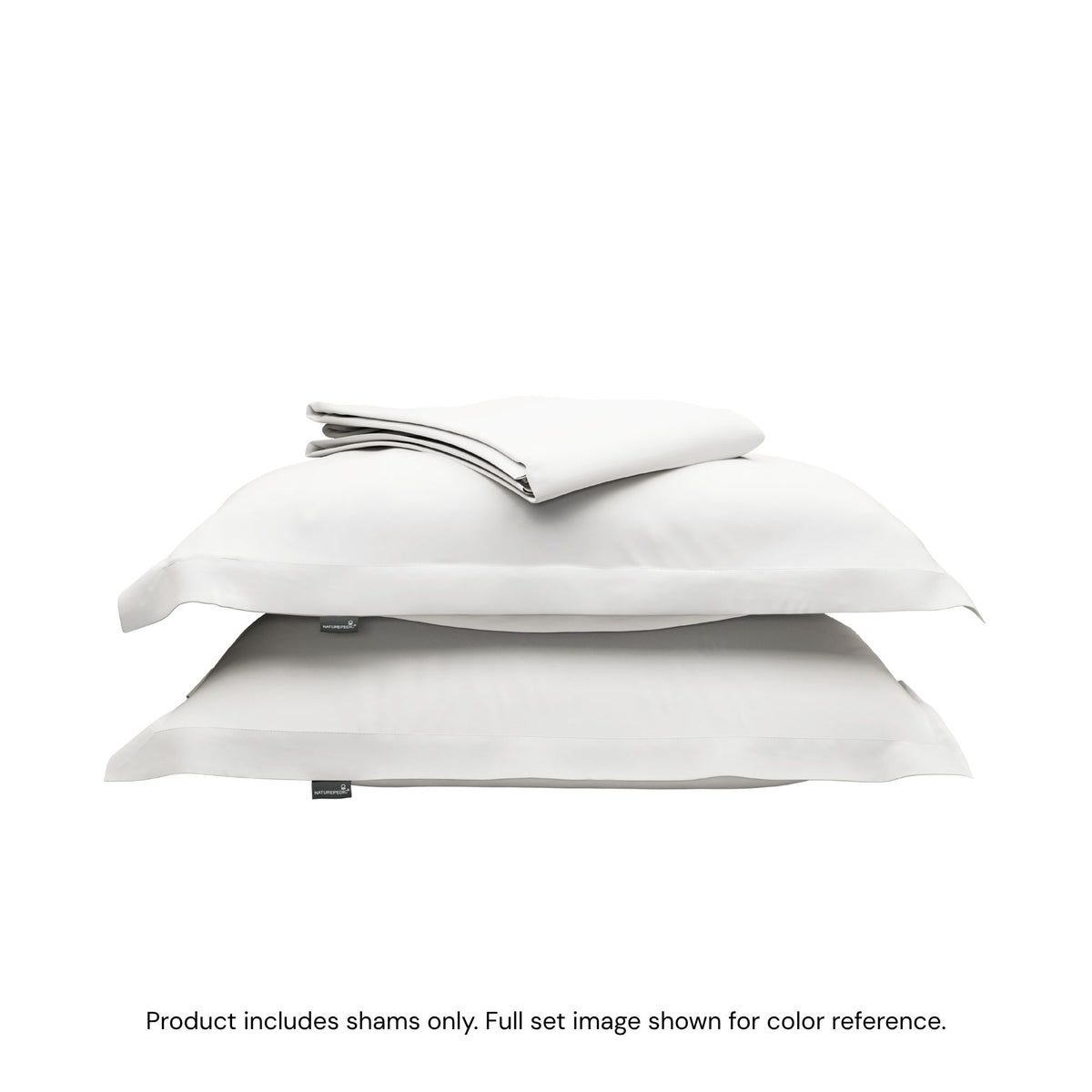 A folded duvet cover on top of two pillow shams. #color_