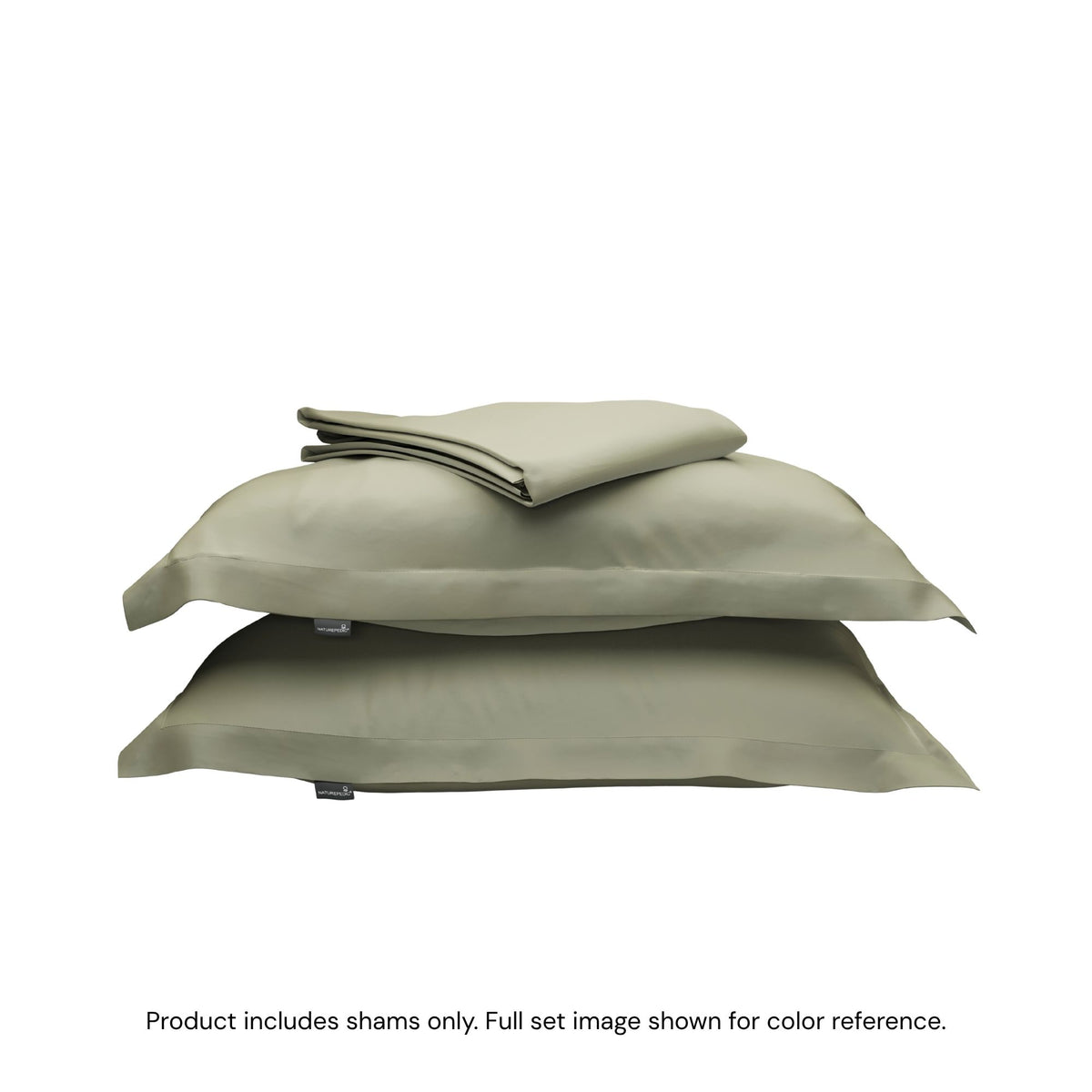 A folded duvet cover on top of two pillow shams. #color_forest canopy