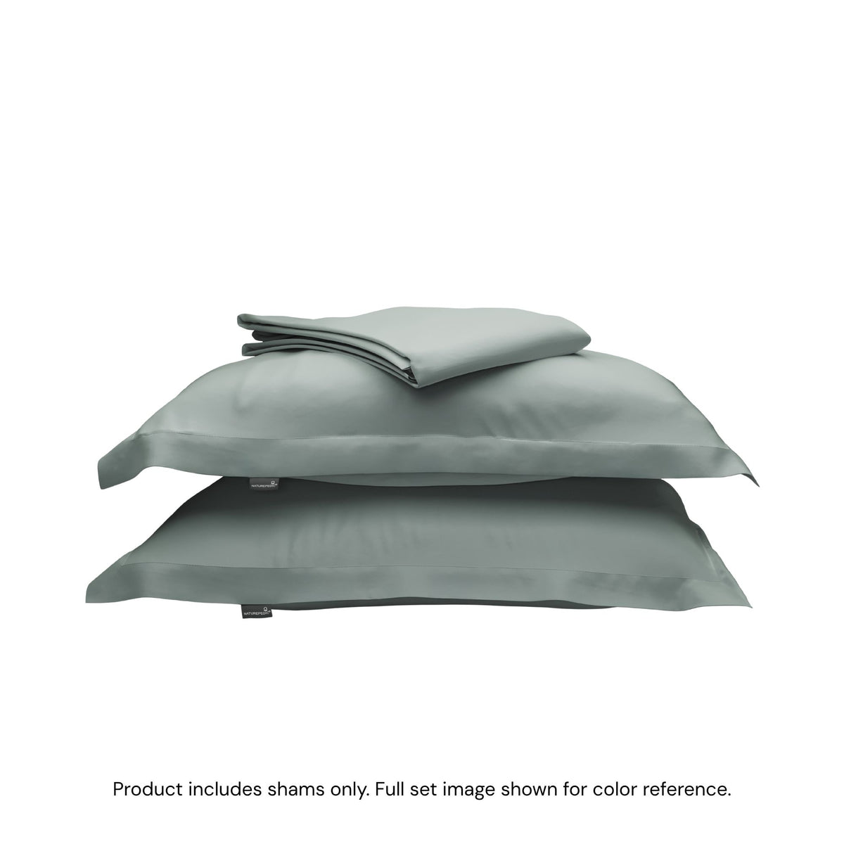 A folded duvet cover on top of two pillow shams. #color_harbor island